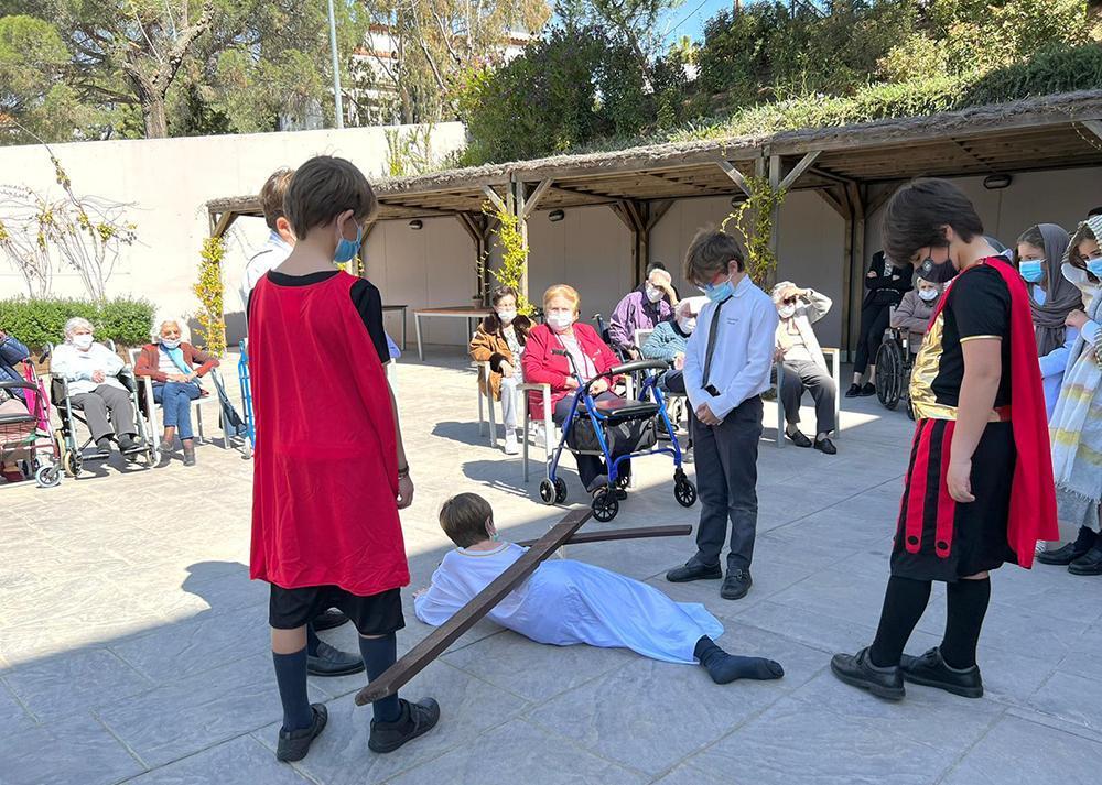 Alumnos de Highlands School Barcelona en una representación de un Vía Crucis viviente para los mayores de la residencia Orpea.